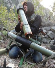 A Syrian opposition fighter checks a rocket launcher amid fighting last week in the country's disputed Latakia province. The Syrian government reported progress in efforts to retake territory near a seaport hosting the removal of its chemical weapons.