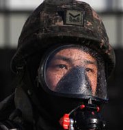 A South Korean soldier participates in a chemical weapons response drill in Seoul last November. A massive expansion of North Korea's premier chemical complex is likely to benefit the nation's chemical weapons production efforts, concludes a new expert analysis.