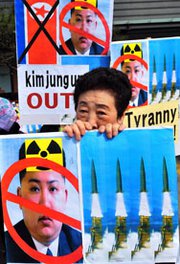 A South Korean activist holds placards that denounce North Korean leader Kim Jong Un at a March rally in Seoul. The North Korean foreign ministry on Tuesday said there was no time limitation for when the nation might carry out its fourth atomic test.