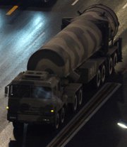 A truck carries a Chinese Dongfeng 31 ICBM to a 2009 military parade rehearsal in Beijing. China is pursuing a capability to equip ICBMs with multiple nuclear warheads, a Chinese state-controlled newspaper said this week (AP Photo/Ng Han Guan).