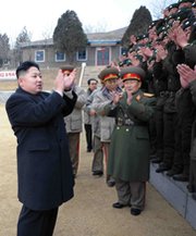 North Korean leader Kim Jong Un, at left, joins military personnel in applause during a January visit to a tank division. Pyongyang’s announcement on Monday of a longer rocket launch window could mean the country’s missile program is becoming more professionalized, one U.S. expert said (AP Photo/Korean Central News Agency).