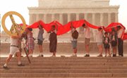 Demonstrators at Washington's Lincoln Memorial, circa 1995, shield themselves from the rain with a banner protesting nuclear weapons. U.S. Congress oversight-reform legislation, prompted by a 2012 activist-trespassing incident at a Tennessee nuclear-materials facility, has been pared back (Joyce Naltchayan/AFP/Getty Images).