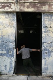 An Everglades National Park, Fla., site coordinator in 2010 opens the doors to one of three facilities used decades ago to store and potentially launch both conventional and nuclear-tipped Nike missiles in reaction to any Russian attack. The U.S. Congress has scaled back earlier demands for costing out alternatives to an Obama administration plan for using a single update package for two different nuclear warheads in today's stockpile (Joe Raedle/Getty Images).