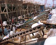 Wheat is unloaded in 2000 from a ship docked at Pakistan's Port of Qasim, today the only seaport still participating in a pilot program on scanning all U.S-bound cargo for weapon-usable radioactive materials. The U.S. Homeland Security Department is expected to seek a four-year extension to a July deadline for all inbound shipments to undergo such scanning, a Government Accountability Office official said on Tuesday (AP Photo/Zia Mazhar).