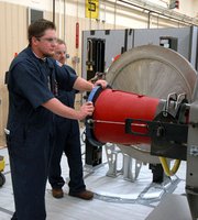 Technicians prepare to transfer a U.S. W-76 nuclear warhead, a weapon deployed on the country's Trident 2 D-5 submarine-launched ballistic missiles. The Pentagon has formulated at least three plans for significantly cutting the quantity of strategic nuclear warheads fielded on U.S. missiles and bombers (U.S. National Nuclear Security Administration photo).