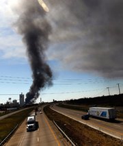 Smoke rises from a 2011 fire at a chemical processing plant in Waxahachie, Texas. U.S. House legislation introduced last Thursday would extend a Homeland Security Department chemical-security program for two years and establish new requirements for the initiative.