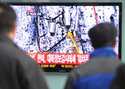 South Korean passengers at a Seoul train station watch television coverage of North Korea's third nuclear test on February 12, 2013. New satellite images show a marked uptick in the pace of digging of a new tunnel at the North's Punggye-ri nuclear testing grounds, an image expert said on Thursday.