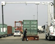 A mobile radiation detector scans cargo containers in 2006 at Port Newark in New Jersey. The Obama administration is set to miss a legal deadline established five years ago for screening all U.S.-bound international cargo for weapon-usable nuclear and radioactive substances (AP Photo/Mike Derer).