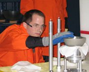 A Defense Nuclear Facilities Safety Board engineer places uranium hemi-shell training models on a moveable platform in preparation for an experiment at Lawrence Livermore National Laboratory. The Energy Department gave the laboratory a high rating for its nuclear criticality safety performance last year.