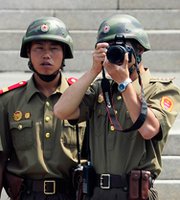 North Korean soldiers gaze across to the South side during a Sunday ceremony marking the 61st anniversary of the signing of the armistice agreement in Panmunjom, South Korea. A senior North Korean military official used the occasion to threaten to carry out nuclear strikes on the White House.