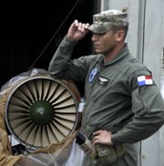 A naval police officer stands on Tuesday near a Russian-made jet engine taken from the North Korean-flagged freighter Chong Chon Gang. The ship seized in Panama earlier this month reportedly contained five vehicles that might include missile control features (AP Photo/Arnulfo Franco).