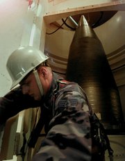 A U.S. Air Force serviceman performs maintenance on a Minuteman 3 ICBM in 1997 in Nebraska. A high-level Air Force body last month endorsed a document describing the need for a land-based successor to the missile system (AP Photo/Eric Draper).