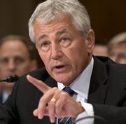 U.S. Defense Secretary Chuck Hagel, shown testifying before a Senate subcommittee on Tuesday, said the Pentagon plans to substantially scale back use of private support contractors (AP Photo/Scott Applewhite).