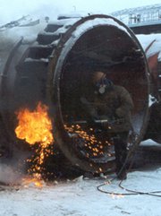 A worker cuts into a ballistic missile submarine launch tube in a destruction effort supported by the Cooperative Threat Reduction program. While most Defense Department work in Russia will cease with the expiration of the program's implementing deal, many Energy Department security projects in Russia will continue, a senior Obama administration official said on Thursday (U.S. Defense Threat Reduction Agency photo).