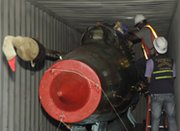 Investigators on Sunday examine a Russian-made MiG fighter jet inside a container on the North Korean-flagged freighter Chong Chon Gang. Panamanian authorities on Sunday said they had found two of the aircraft aboard the vessel intercepted earlier this month (AP Photo/Arnulfo Franco).