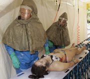 Emergency personnel treat a victim of a mock nuclear explosion during a 2006 exercise in Honolulu. Rutgers New Jersey Medical School is considering a plan to increase its focus on terrorism threats.
