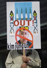 A South Korean protester displays a placard during an anti-North Korea rally in Seoul in March. North Korea on Friday announced it had successfully tested a new precision-guided tactical missile that could be used to better target the South.