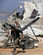 A Syrian rebel fighter fires a mortar towards pro-regime forces in a clash on the outskirts of Aleppo last week. U.S. Secretary of State John Kerry on Thursday said it remained unclear how an international standoff over Ukraine might affect efforts to remove chemical arms from Syria.