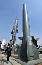 A boy runs past a replica of North Korean Scud-B missile at the Korean War Memorial in Seoul on Wednesday, the same day that Pyongyang test-fired two medium-range ballistic missiles.