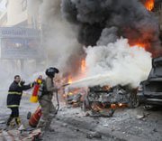 Firefighters seek to contain flames from an apparent January suicide bombing in a Hezbollah stronghold in Beirut, Lebanon. U.S. legislators are considering a potential push to impose new sanctions on Iran for supporting Hezbollah.