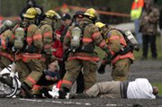 Firefighters respond to a simulated radiological "dirty bomb" attack during a 2007 drill in Portland, Ore. The White House is backing a plan to relax cleanup standards following such incidents, federal officials say in a draft report (AP Photo/Rick Bowmer).