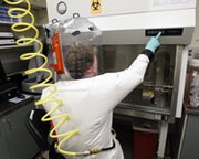A scientist works in a Biosafety Level 4 laboratory at the U.S. Army Medical Research Institute of Infectious Diseases in Fort Detrick, Md. Inspectors last week found a sample of a lethal virus had gone missing from a maximum-security area of the Galveston National Laboratory in Texas (AP Photo/Patrick Semansky).