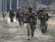 U.S. Marines march south of Seoul last month as part of military exercises staged with South Korea. A senior Defense Department official on Tuesday said the Pentagon’s ability to keep forces ready for possible Korean Peninsula hostilities might be harmed by any long-term budget reduction mandates (AP Photo/Lee Jin-man).