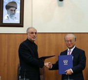 Iranian Atomic Energy Organization head Ali Akbar Salehi, left, shakes hands on Nov. 11 with International Atomic Energy Agency Director General Yukya Amano, as they reached a deal for greater IAEA oversight of Iran's nuclear program (Atta Kenare/AFP/Getty Images).