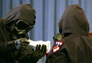 (Aug. 27) -Two U.S. Army soldiers in WMD response gear during a 2002 demonstration at the Pentagon. The Defense Department has shifted more than $1 billion from WMD defense projects to help fund a new federal vaccine development and production program (Paul Richards/Getty Images).