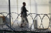 (Apr. 26) -A detainee in September walks through the recreation yard at the U.S. detention center for "enemy combatants" at Guantanamo Bay, Cuba. The top al-Qaeda planner of the September 11 strikes on the United States claimed the organization would conduct a nuclear attack if leader Osama bin Laden was captured or killed, according to leaked official documents (John Moore/Getty Images).