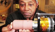 A Sandia National Laboratories scientist works on a project related to modernizing U.S. nuclear weapons. A key Energy Department official says reducing the amount of money the government pays to the companies that run the national labs -- and simultaneously increasing the amount of funds available for scientific work -- could improve overall performance at the facilities.